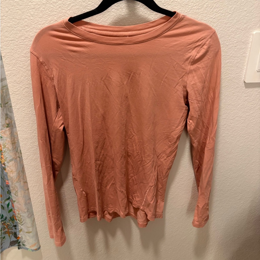 Lululemon long sleeve in a light pink color.